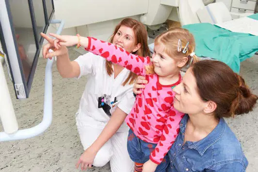 Radiolog viser jente og mammaen hennes bildene